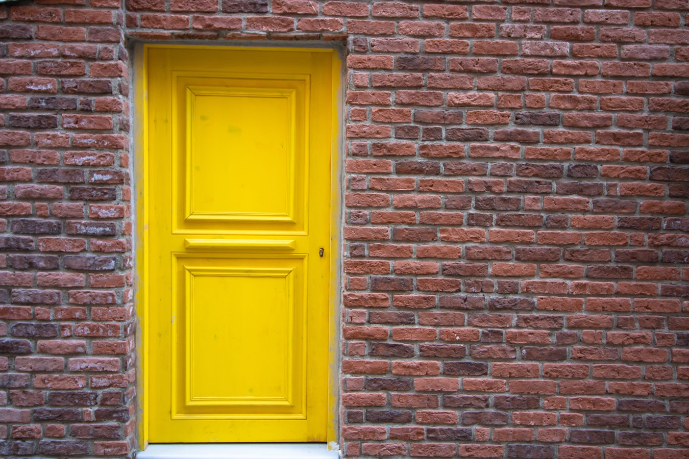 brick wall and yellow door